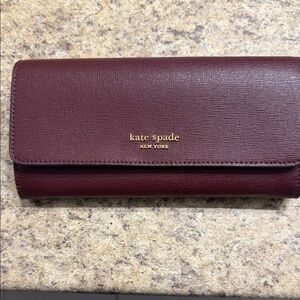 kate spade Burgundy Saffiano Leather Continental Wallet with Gold Logo